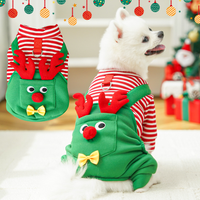 White bichon wearing christmas reindeer pet jumpsuit festive photo"