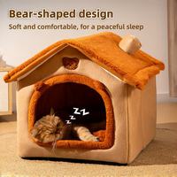 Bear-shaped enclosed plush cat bed with a cat sleeping inside, soft cozy pet house.