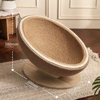 Large fluffy cat sitting inside eggshell sisal cat scratcher bed
