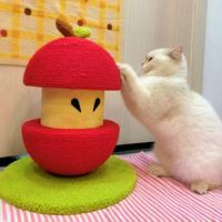 Fluffy white cat scratching red apple sisal cat scratcher indoors