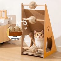 Cat scratcher featuring rope wrapping and hanging interactive toy balls inside.
